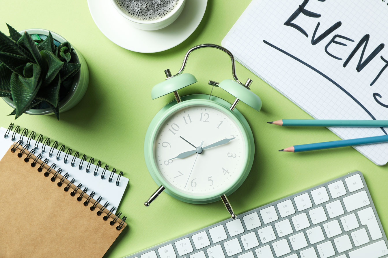 A green alarm clock and a keyboard.